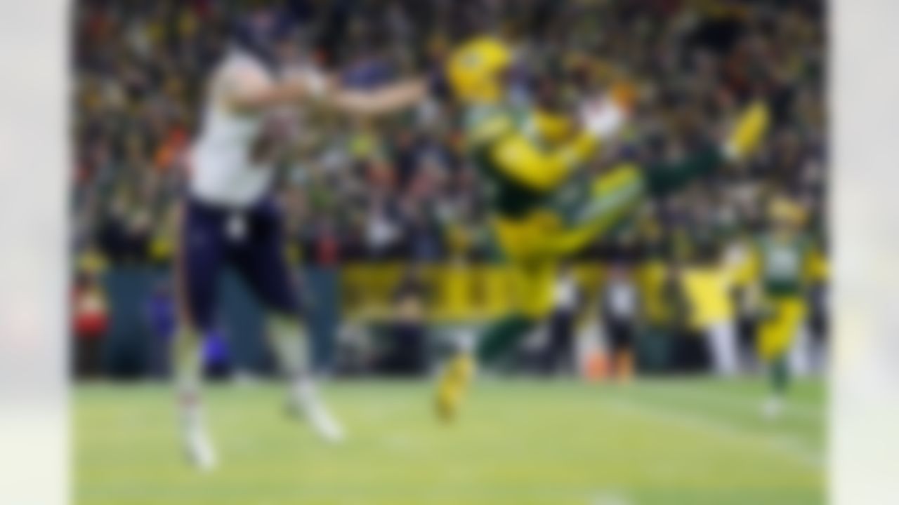 Green Bay Packers cornerback Keisean Nixon (25) intercepts a pass against Chicago Bears tight end Cole Kmet (85) during the second half of an NFL football game Sunday, Dec. 7, 2025, in Green Bay, Wis.