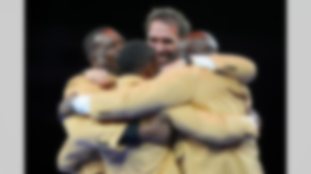 Hall of Fame inductees Eric Allen, Antonio Gates, Jared Allen, and Sterling Sharpe embrace during the Pro Football Hall of Fame Gold Jacket Dinner on Friday, August 1, 2025 in Canton, Ohio.