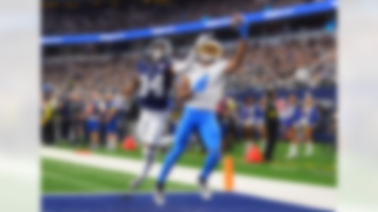 Los Angeles Chargers wide receiver Quentin Johnston (1) makes a touchdown catch past Dallas Cowboys cornerback Shavon Revel during the first half of an NFL football game Sunday, Dec. 21, 2025, in Arlington, Texas.