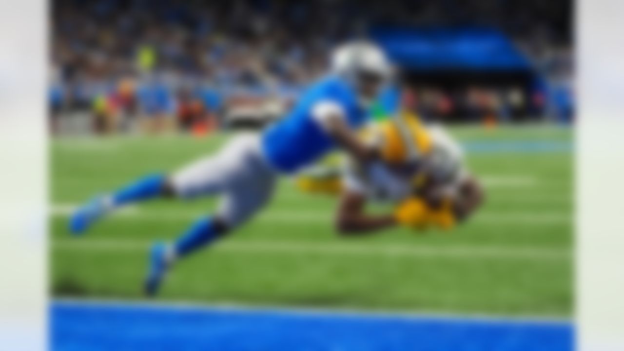 Green Bay Packers wide receiver Dontayvion Wicks (13) dives in for a touchdown under Detroit Lions cornerback Terrion Arnold (6) during the second half an NFL football game in Detroit, Thursday, Nov. 27, 2025.