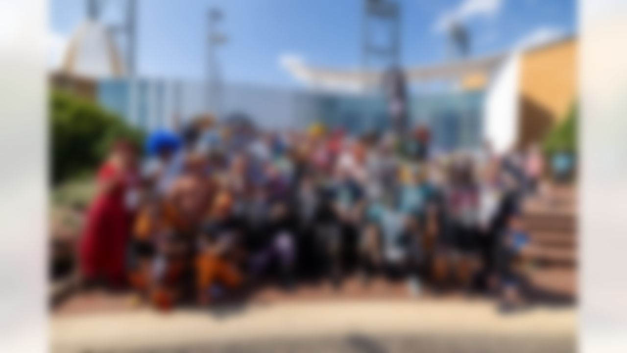 NFL fans pose for a photo during the Play Football First Play on Wednesday, July 30, 2025 in Canton.