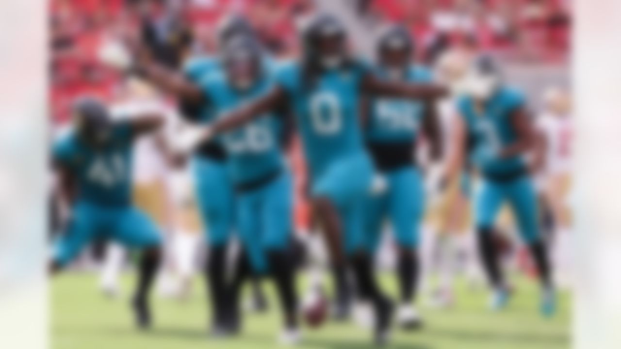 Jacksonville Jaguars linebacker Devin Lloyd (0) celebrates with teammates after intercepting a pass against the San Francisco 49ers during the second half of an NFL football game in Santa Clara, Calif., Sunday, Sept. 28, 2025.