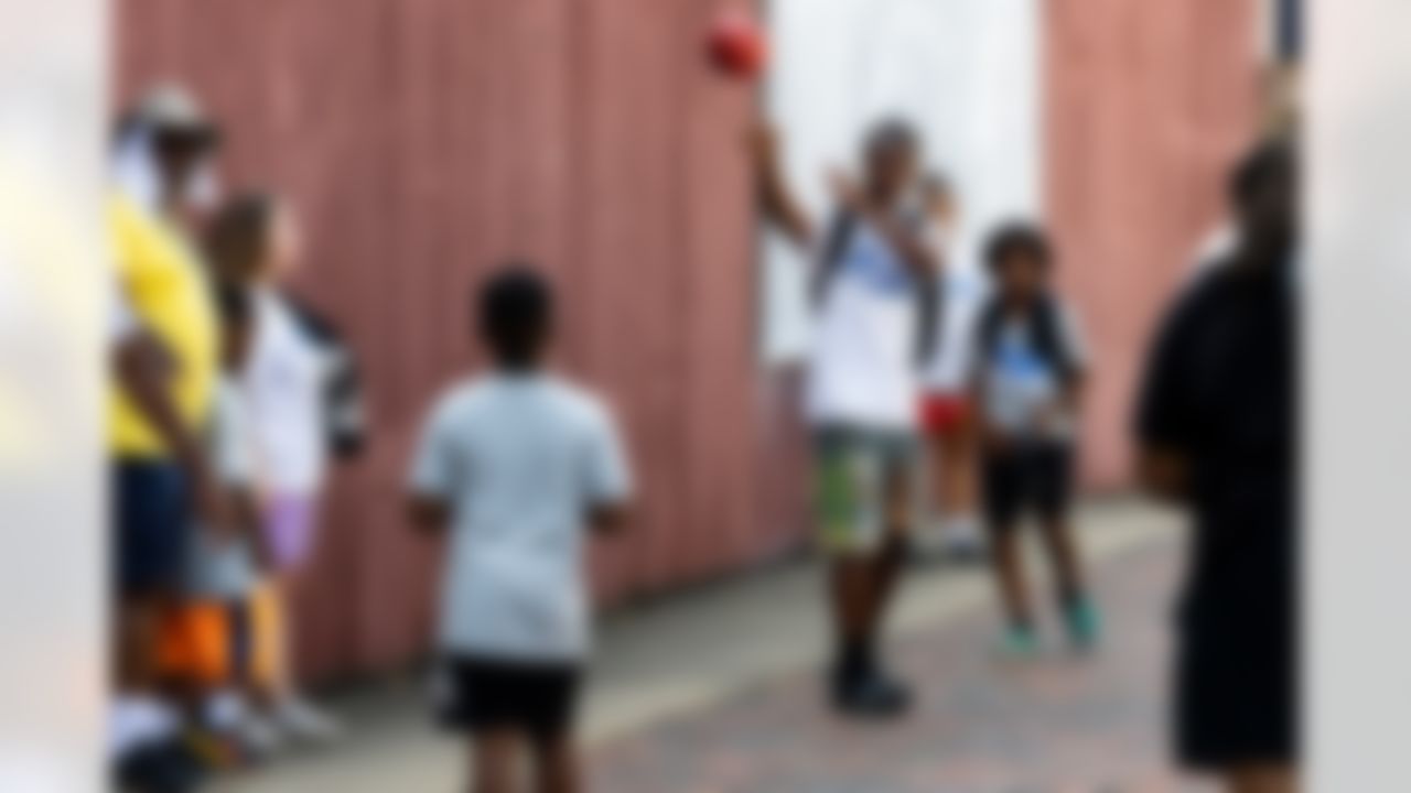 Kids pass the football during the Play Football First Play on Wednesday, July 30, 2025 in Canton.