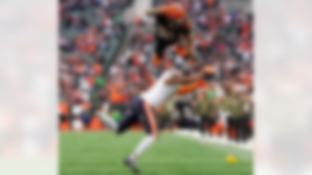 Cincinnati Bengals running back Chase Brown (30) hurdles Chicago Bears defensive back Kevin Byard III (31) on a run during an NFL football game, Sunday, Nov. 2, 2025, in Cincinnati.