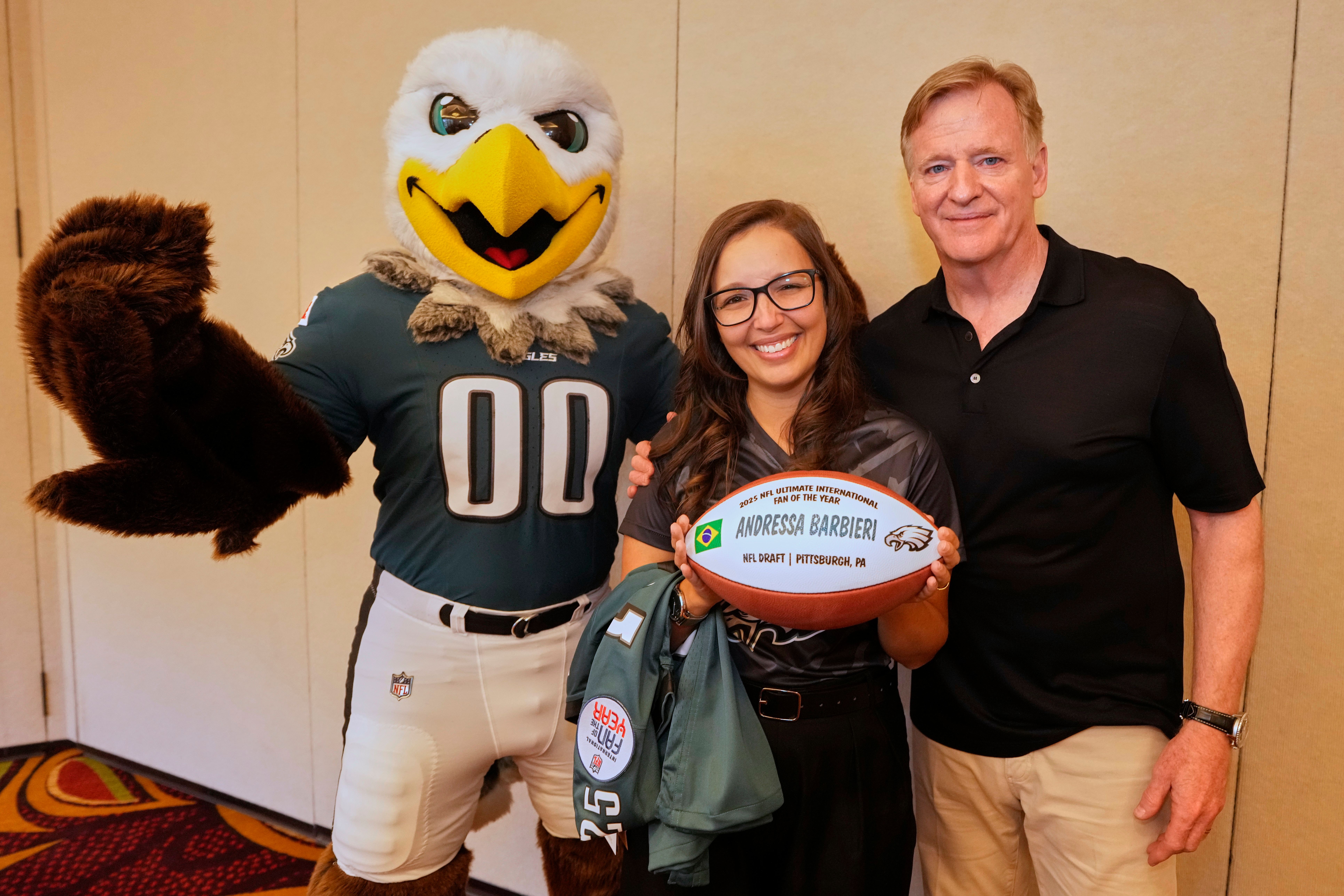 Eagles mascot SWOOP, from left, Andressa Barbieri, Ultimate International Fan of the Year, and NFL Commissioner Roger Goodell, during the Commissioner's Q&A Wednesday, April 22, 2026, in Pittsburgh.(Doug Benc/AP Content Services for the NFL)