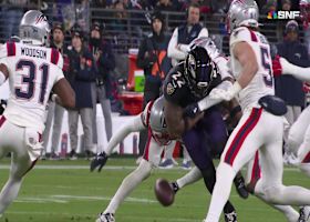 Jaylinn Hawkins winds up to knock the ball loose from Henry for a Patriots takeaway