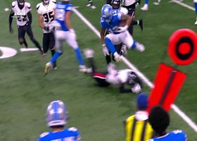 Hurdle alert! Craig Reynolds leapfrogs a Texan as he picks up first-down yardage