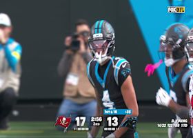 Tetairoa McMillan catches the Bryce Young 11-yard pass despite tight Bucs coverage