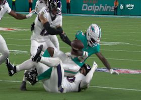 Buchanan's corkscrew tackle meets Gilman's strip tackle for a Dolphins fumble