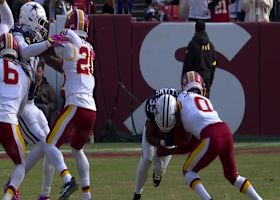 Javonte Williams lowers the BOOM on Sainristil during truck-stick run