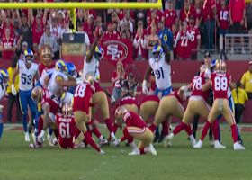 Jared Verse stretches over the 49ers O-Line to block the PAT